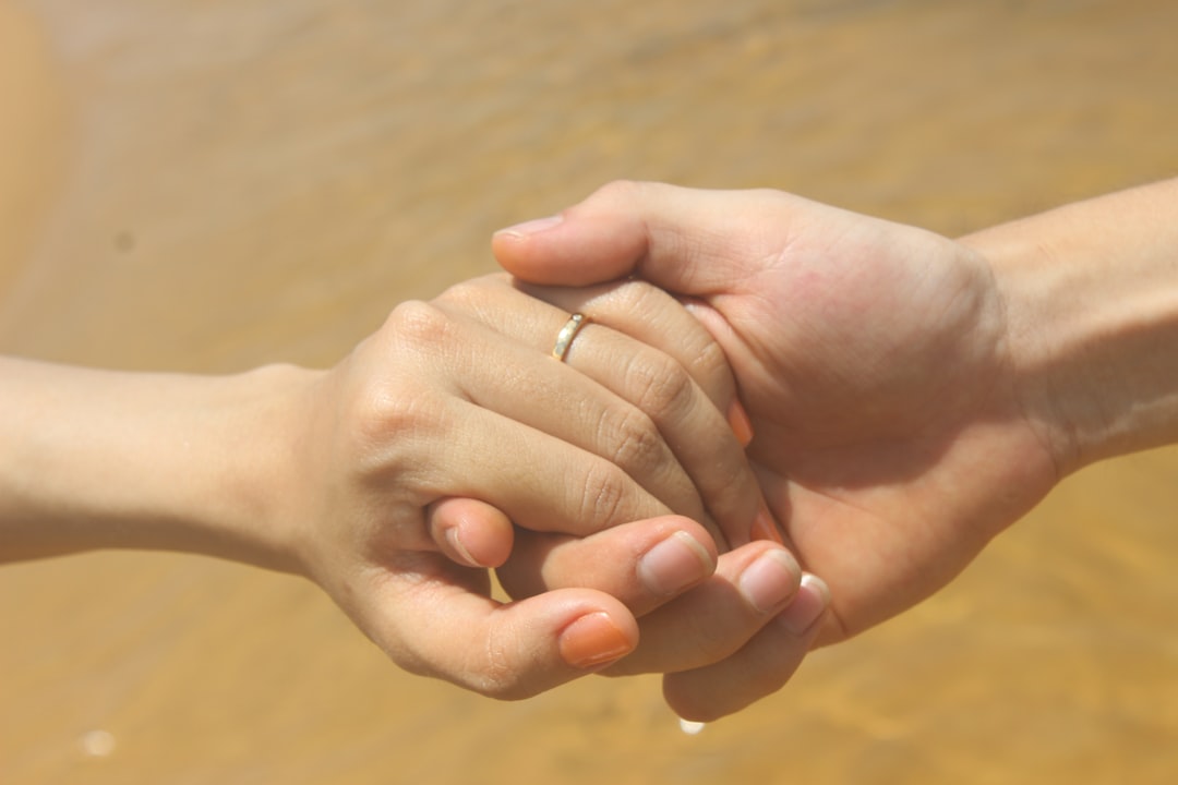 A couple holding hands, warm and unposed