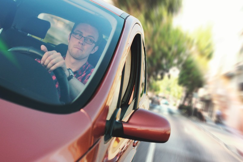 Man Driving the Red Vehicle to maintain routine during COVID 19. Online therapy in Oregon can help with overwhelm and anxiety from coronavirus while you work from home.