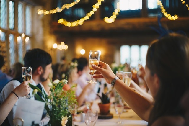 Guests lifting a glass at a wedding to illustrate how the coronavirus has impacted social gatherings. If you need help coping, we offer counseling services in Tigard, OR and online throughout Oregon.