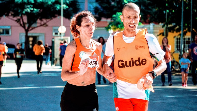 man woman holding hands running race together and helping one another. Our therapists can help you run the race called life.