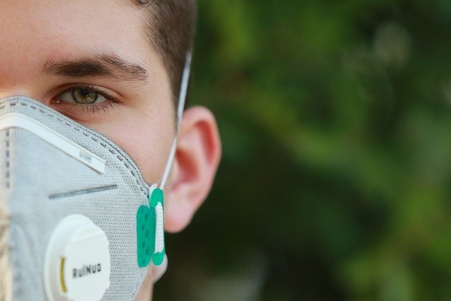Person in N95 mask with only eyes showing due to the Coronavirus pandemic that is causing more social anxiety in Tigard, OR and beyond. You can get help for anxiety, grief and loss, and life transitions during COVID 19 with online therapy in Oregon here!