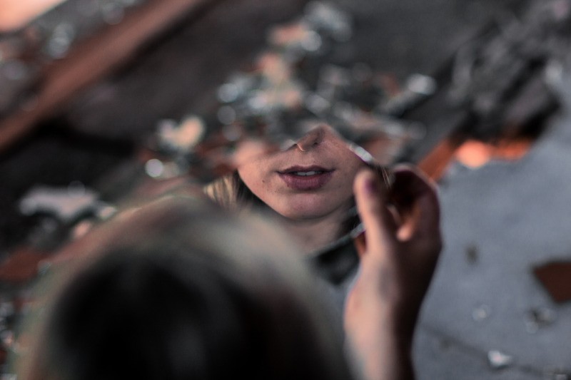 Woman's face in a broken mirror. She feels disconnected from herself after relationship problems. Couples therapy in Tigard, OR can help. You can get help with couples counseling in Tigard, or Online therapy in Oregon!