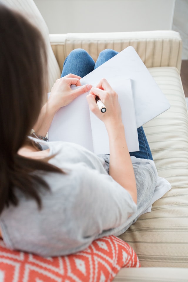 Woman writes her relationship problems in a journal. Couples counseling in Tigard, OR can help if you are honest and open. Rediscover love in couples therapy here. Online therapy in Oregon can help too!