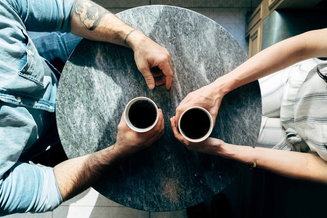 Married man and woman drinking coffee to talk about couples counseling. Getting help for relationship problems or discernment counseling for couples therapy in Tigard, OR can be a good fit. Online therapy for couples in Oregon can help too!