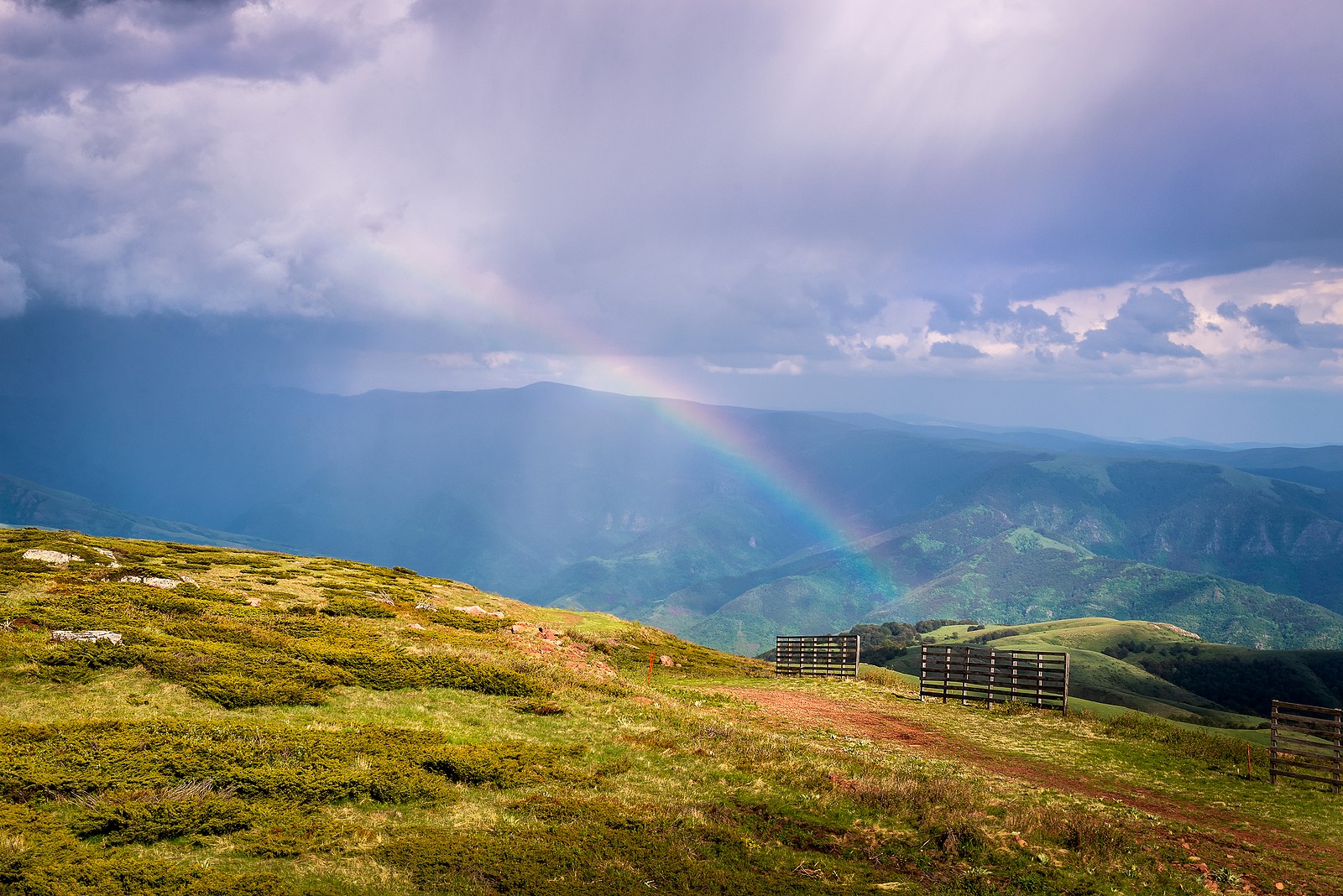 Rainbow over a farm in the mountains representing knowing your limits. Begin online therapy in Oregon with an online therapist from Discover Counseling