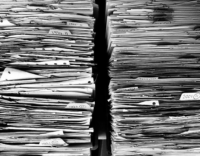 A stack of files and bills for medical and mental health care support. Online therapy in oregon with an anxiety therapist in Tigard, OR can help you find balance and peace again.
