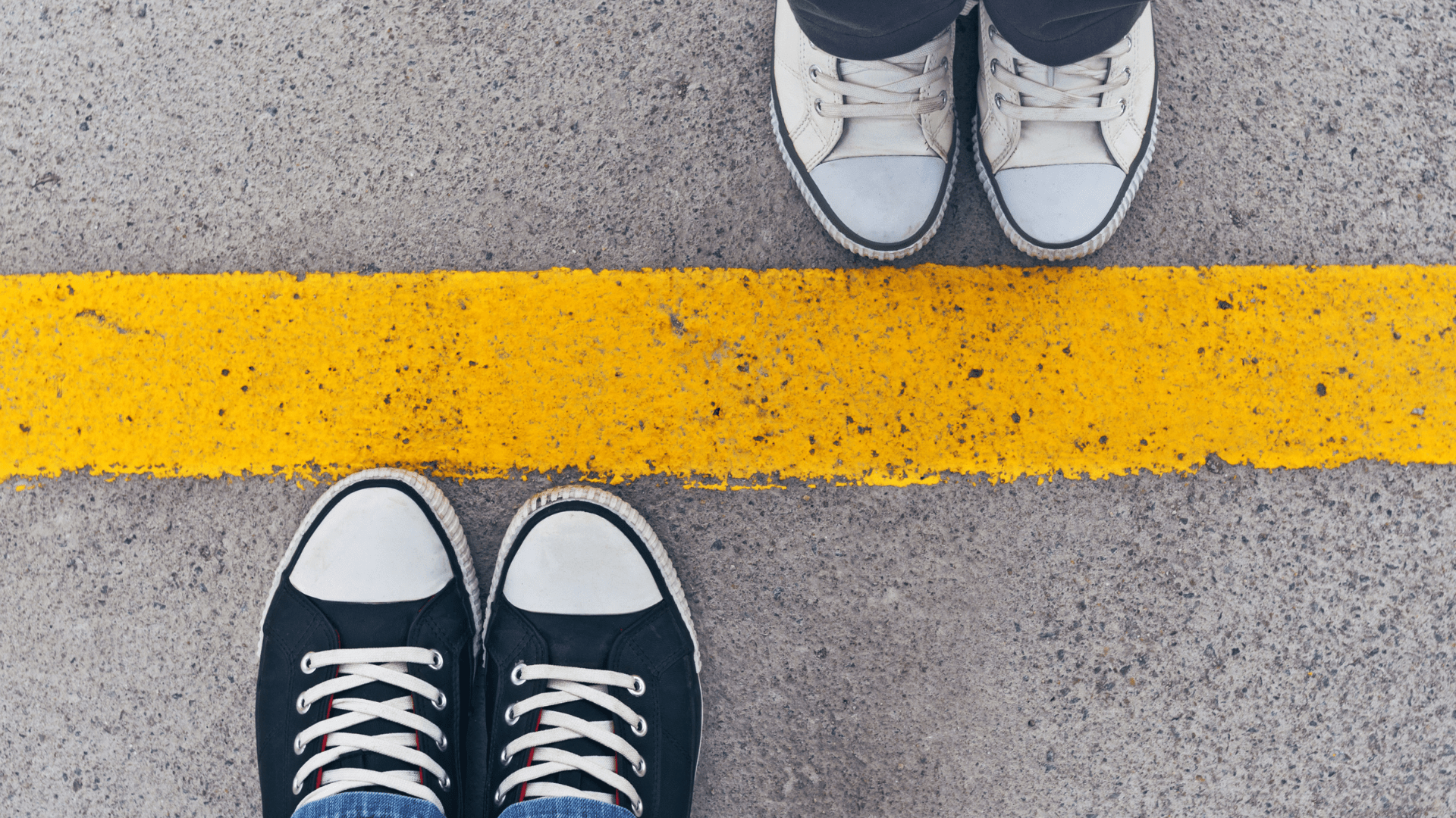 Shoes | Therapy for relationship issues | online therapy in Oregon | codependency treatment in Tigard, OR Shoes against a yellow line on the street. Codependency treatment in Tigard, OR can help with therapy for relationship issues via online therapy in Oregon.