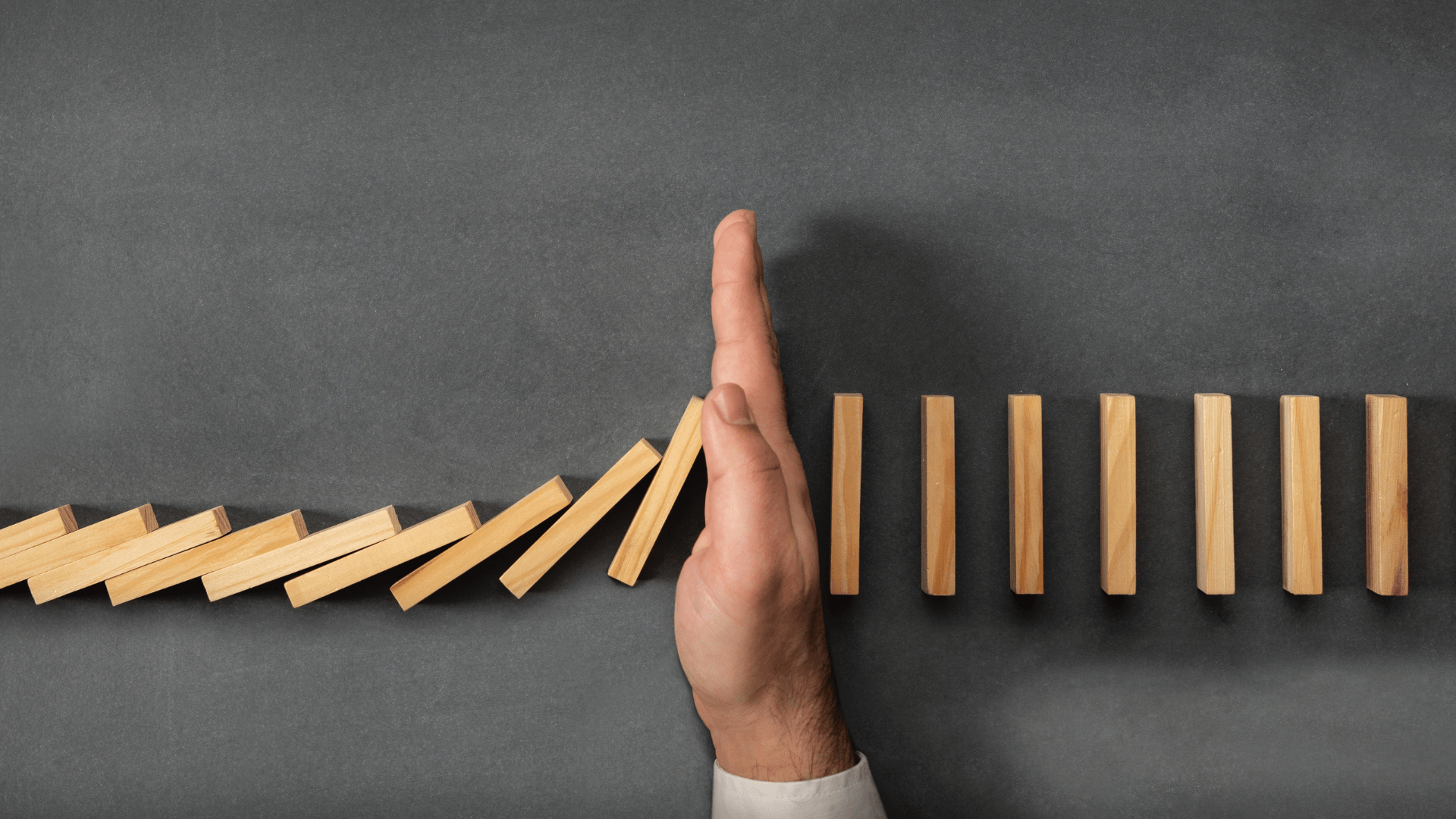 Dominos | Therapy for relationship issues | Codependency Treatment in Tigard, OR | online therapy in Oregon Dominos or wooden blocks set up in a line. Falling against each other until a hand blocks them from falling. Codependency treatment in Tigard, OR can help with therapy for relationship issues via online therapy in Oregon.