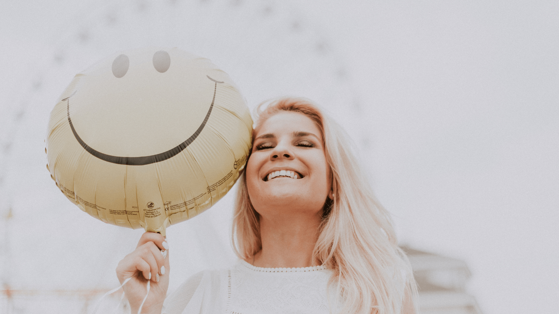 smiley face | therapy for life transitions Tigard, OR | depression treatment Tigard, OR | online therapy Oregon | social anxiety | therapist Tigard | 97223 Image of a woman smiling while holding a yellow smiley face balloon. A therapist in Tigard can help you switch your mindset. Face life transitions with a positive attitude with the help of therapy for life transitions in Tigard, OR. 97223