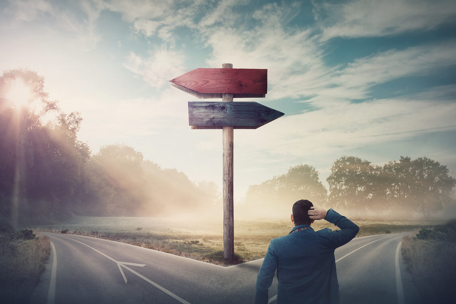 Image of a man at a split in the road with a sign that points both directions showing the types of decisions that stress counseling in Tigard, OR can help with. Through online therapy and online therapist can make moving forward in life easier.