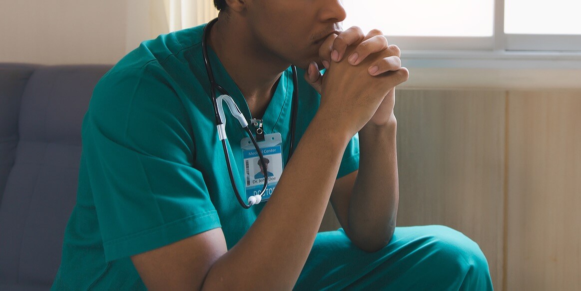 A person in scrubs sits resting their hands on their head. Learn how anxiety counseling in Tigard, OR can offer support in managing anxiety symptoms. Search for an anxiety counselor to learn more about social anxiety in Tigard, OR today.
