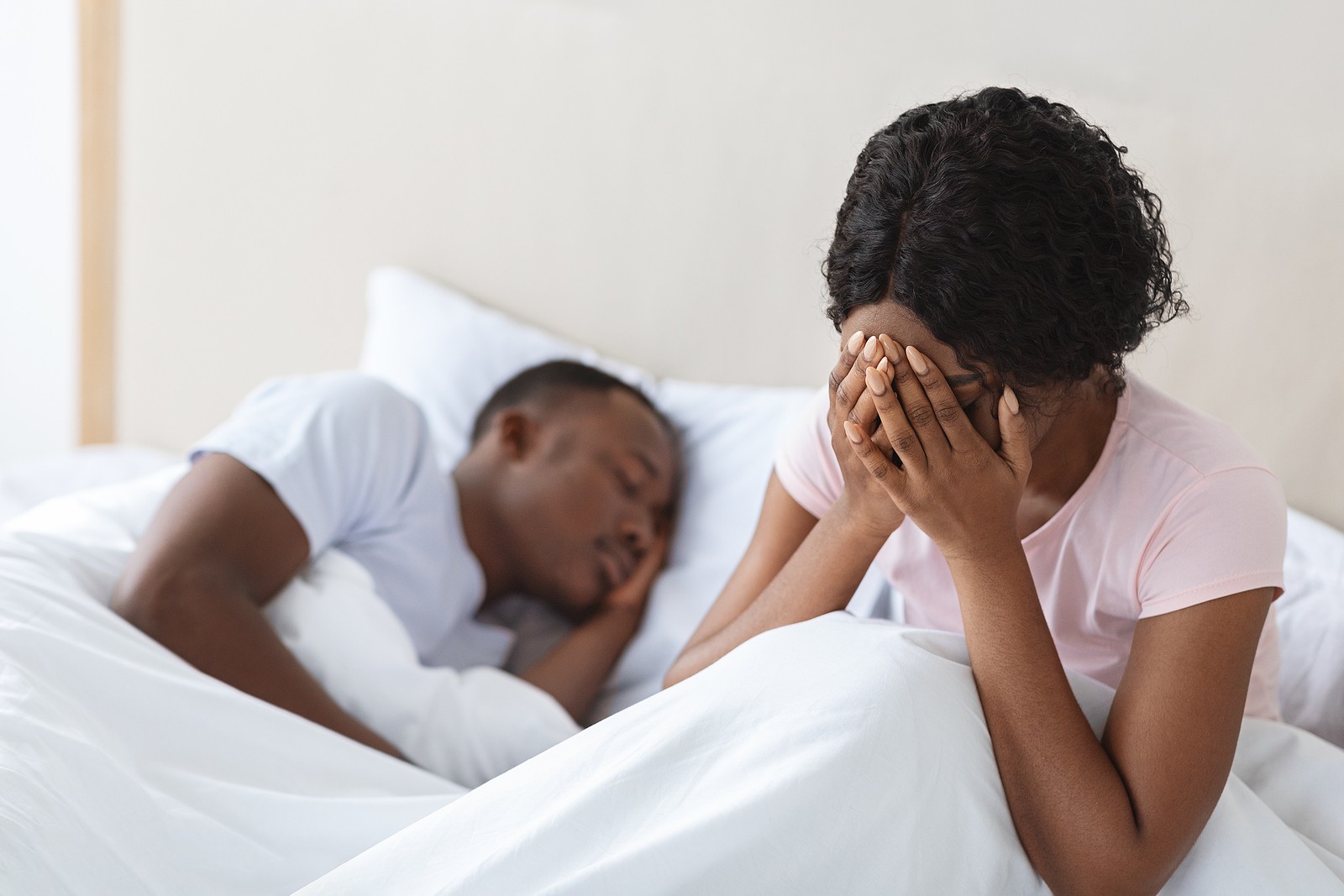 covering face | online therapist in oregon | relationship therapy in tigard, or | therapy for relationship issues | 97086 | 97201 | 97202 A woman sits up in bed while covering her face as her partner sleeps nearby. Learn how an online therapist in Oregon can support you in addressing the effects of codependency. Search for relationship therapy in Tigard, OR to learn about other services.
