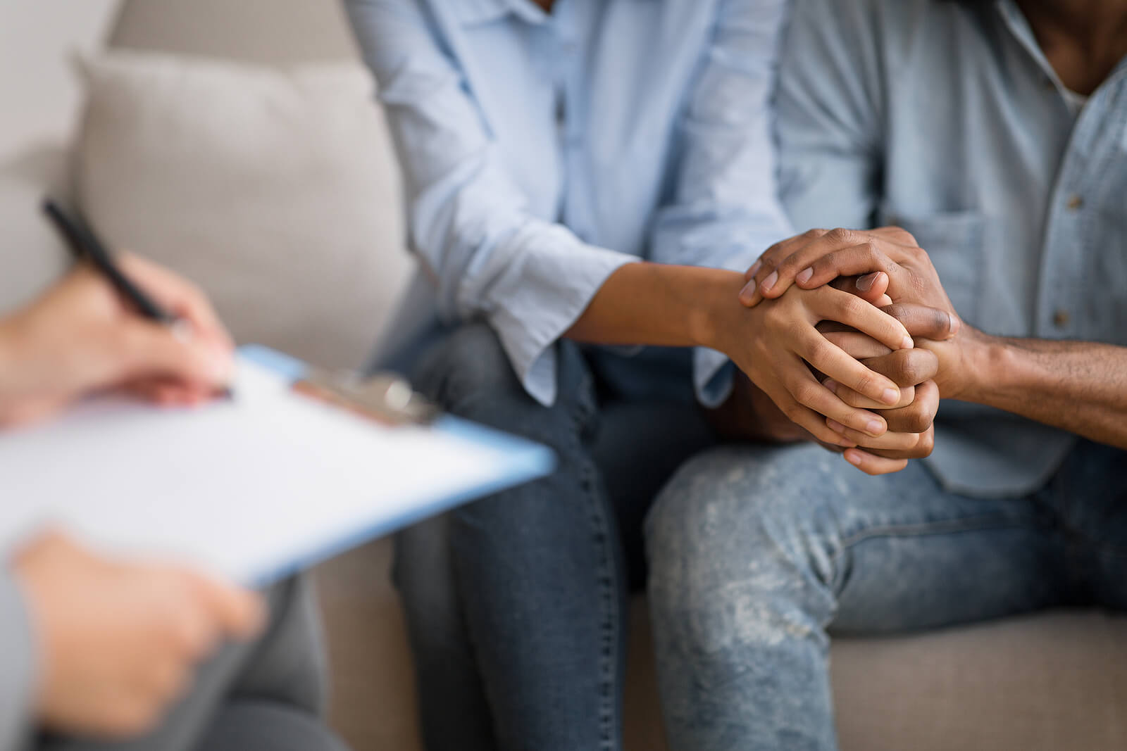 writing notes | codependency counseling | online therapy for codependency | symptoms of codependency tigard, or | 97223 | 97224 | 97281 A close up of a person writing on a clipboard while sitting across from a couple. This could represent the support offered via codependency counseling. Contact a therapist for more support in addressing symptoms of codependency Tigard, OR.