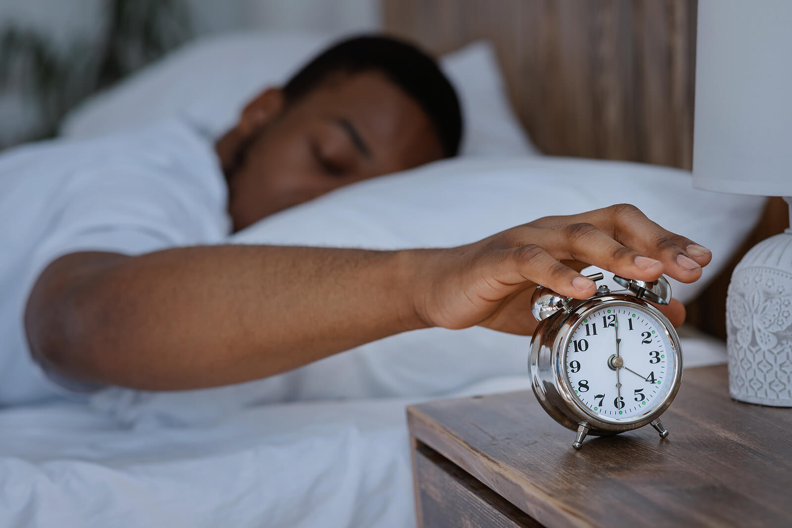alarm | stress counseling in tigard, or | oregon online therapist | anxiety counselor tigard | 97223 | 97224 | 97281 A man touches an alarm clock while laying in bed. This could represent the struggles with sleep that stress counseling in Tigard, OR can address. Learn more about anxiety counseling in Tigard, OR, and the help an online therapist in Oregon can offer.
