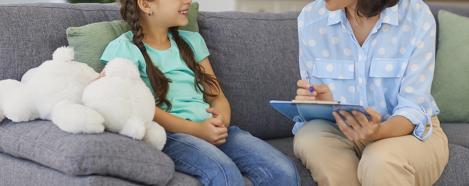 child and adult | child therapist in tigard, or | child counseling | child therapist near me | 97223 | 97224 | 97281 A woman smiles while writing on a clipboard and talking on the sofa. Search for child counseling in Tigard, OR and the help a child therapist in Tigard, OR can offer. Search for a child therapist near me for help!