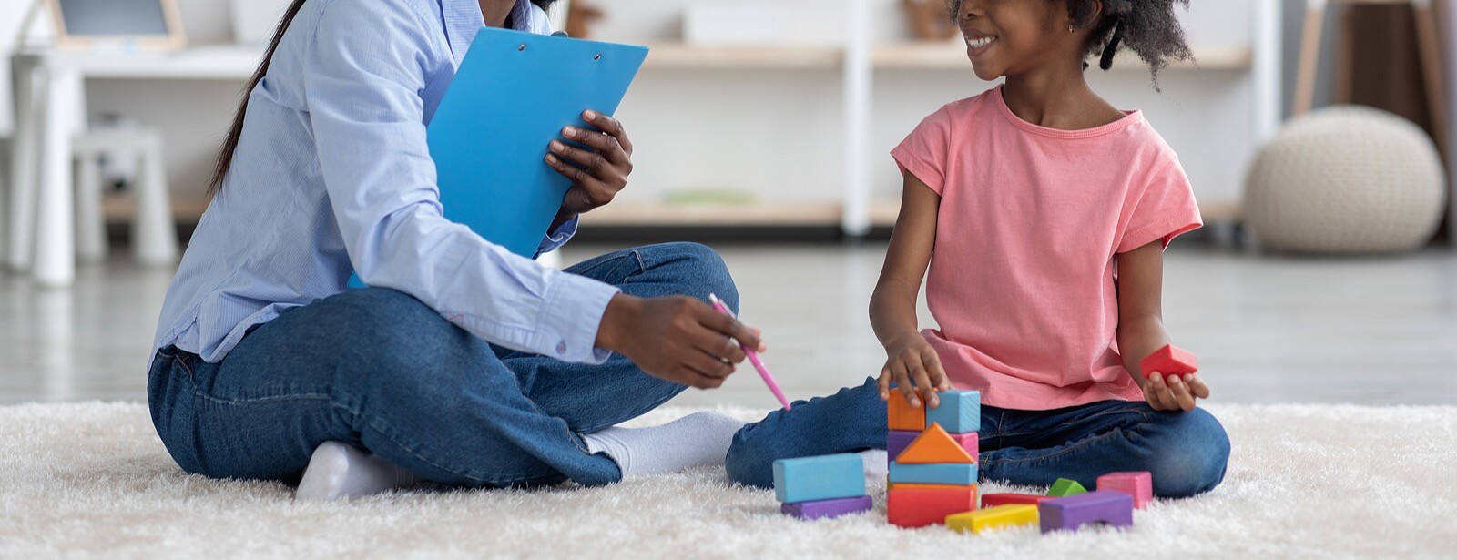 smiling child | child therapist in tigard, or | online therapist in oregon | child counseling | 97223 | 97224 | 97281 A child smiles while playing with blocks in front of a therapist. This could represent the support a child therapist in Tigard, OR can offer. Search for an online therapist in Oregon for help with child counseling in Tigard, OR today.
