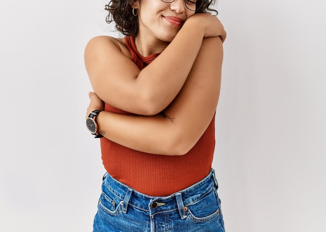 A woman smiles while hugging herself. This could represent cultivating a positive self image by working with a stress counselor in Tigard, OR. Search for counseling in Tigard, OR and the help that Oregon online therapy can offer. Search for a therapist tigard today for tips.
