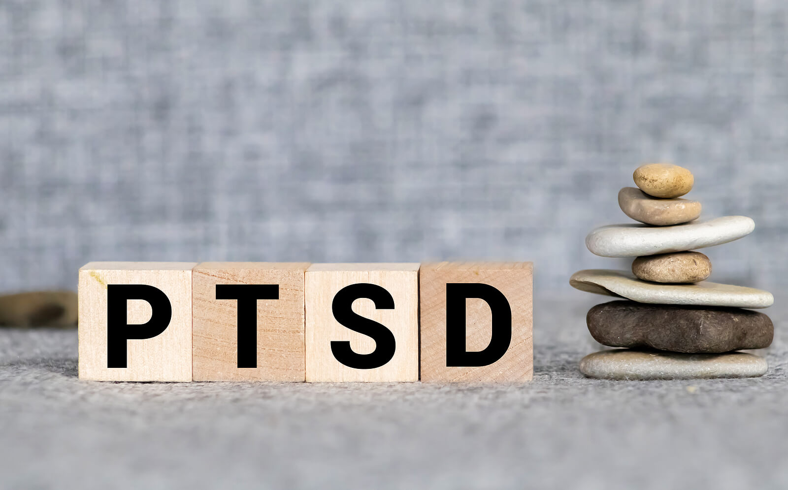 ptsd | trauma therapy in tigard, or | therapist tigard | trauma counseling in tigard, or | 97223 | 97224 | 97281 A close up of block letters that spell PTSD next to stacked rocks. Learn how trauma therapy in Tigard, OR can help you address PTSD symptoms and achieve trauma recovery in Tigard, OR. Learn more about how an online therapist in Oregon can offer support today.