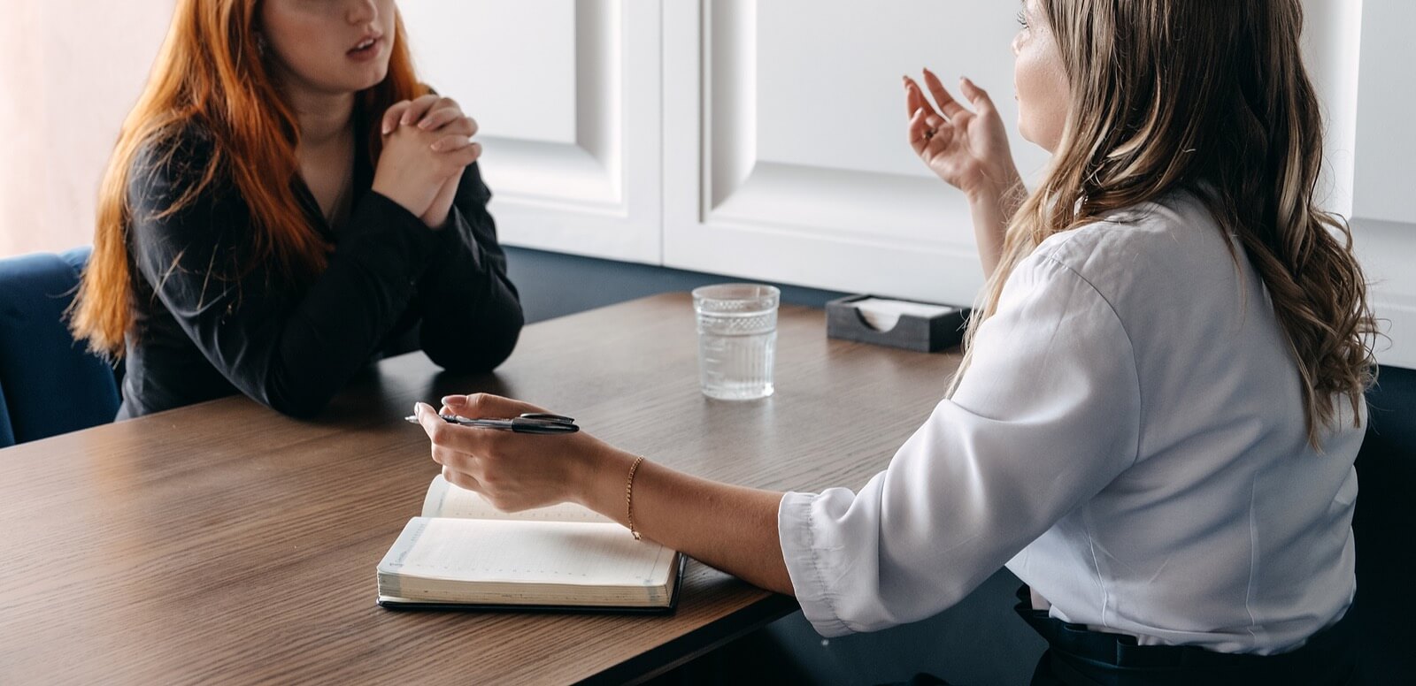 supportive woman | trauma therapy in tigard, or | trauma recovery in tigard, or | trauma therapy tigard, or | 97223 | 97224 | 97281 A woman sits across from a person with a pen and clipboard. This could represent the support that trauma therapy in Tigard, or can offer. Search for trauma counseling in Tigard, OR or search for an online therapist in Oregon for more support.