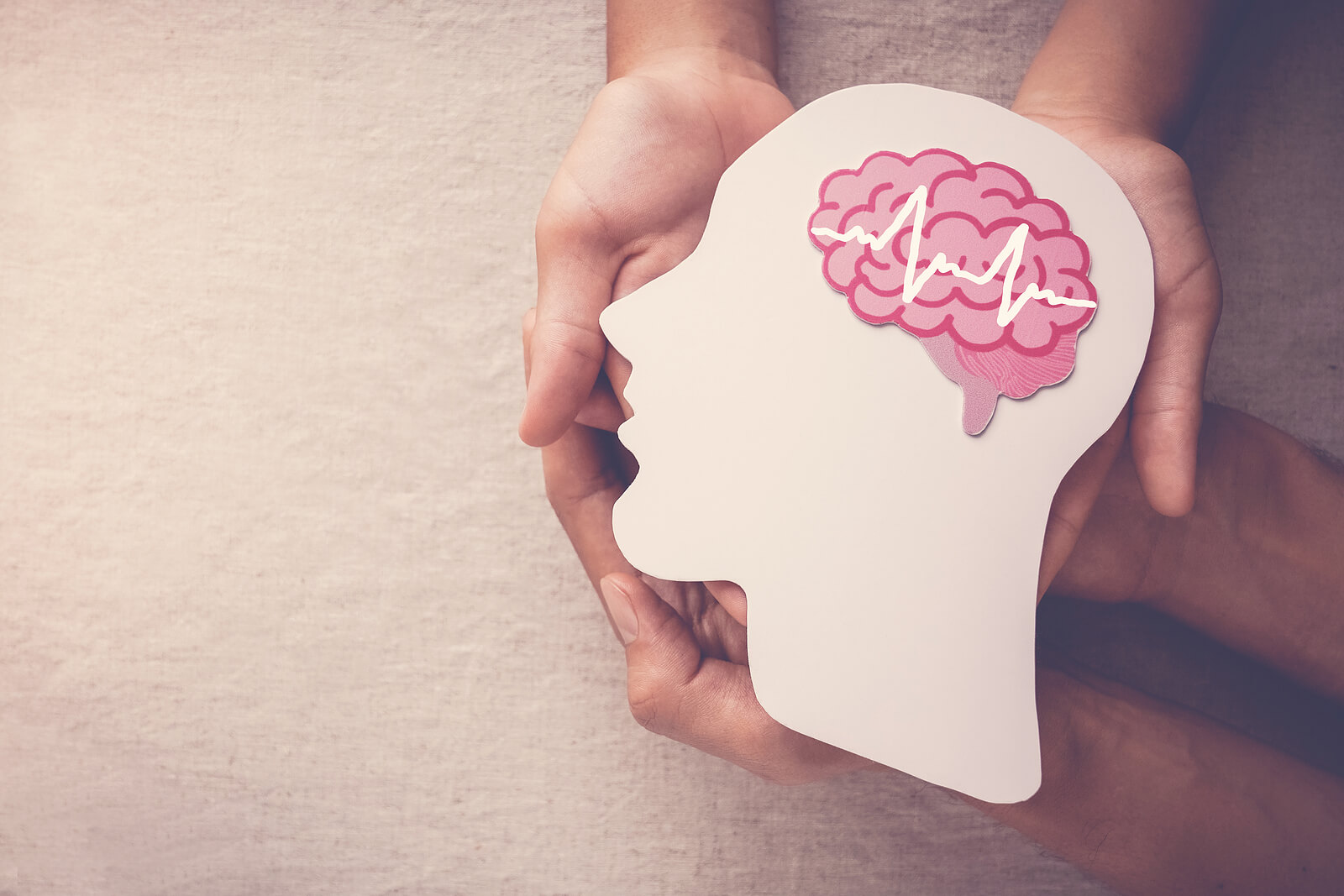 A close up of hands holding a profile of a head with the image of a brain. This could represent benefits of a cognitive form of counseling services in Tigard, OR. Search for counseling in Tigard, OR or "oregon online therapist" to learn more about online counseling in Orgeon and other services. 
