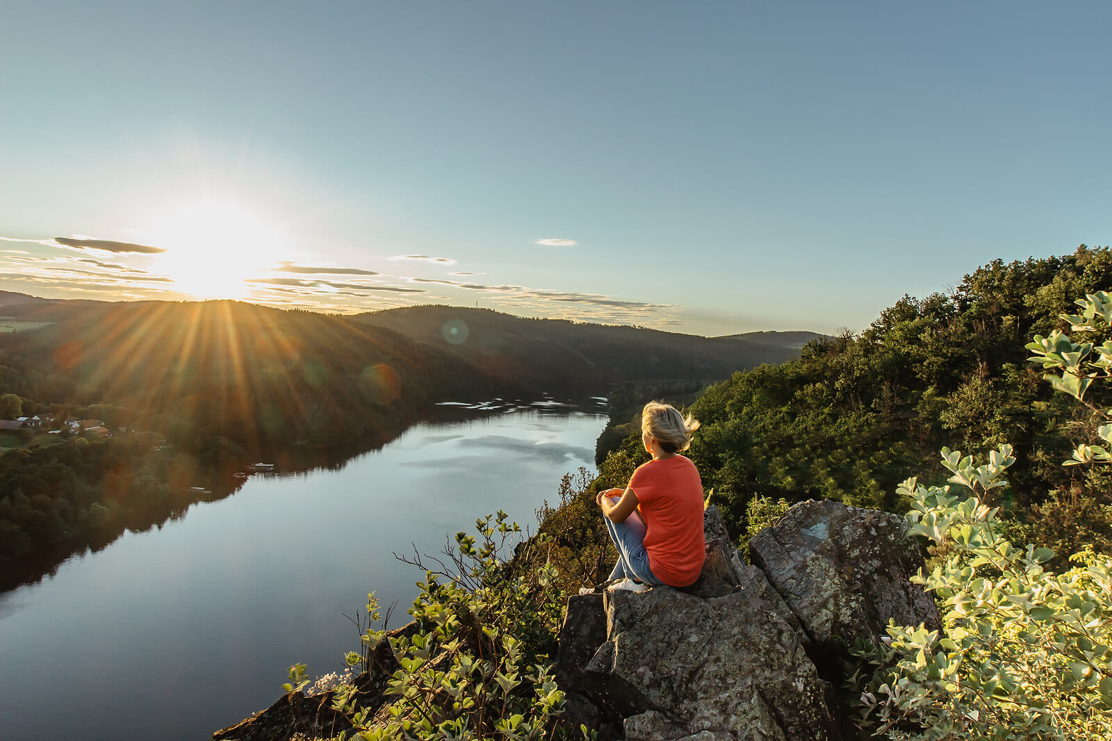 A woman sits while overlooking a river. This could represent the benefits of nature therapy in Tigard, OR, and reconnecting with the world. Learn how anxiety therapy in Tigard, OR can offer support by searching for a stress counselor in Tigard, OR today. 
