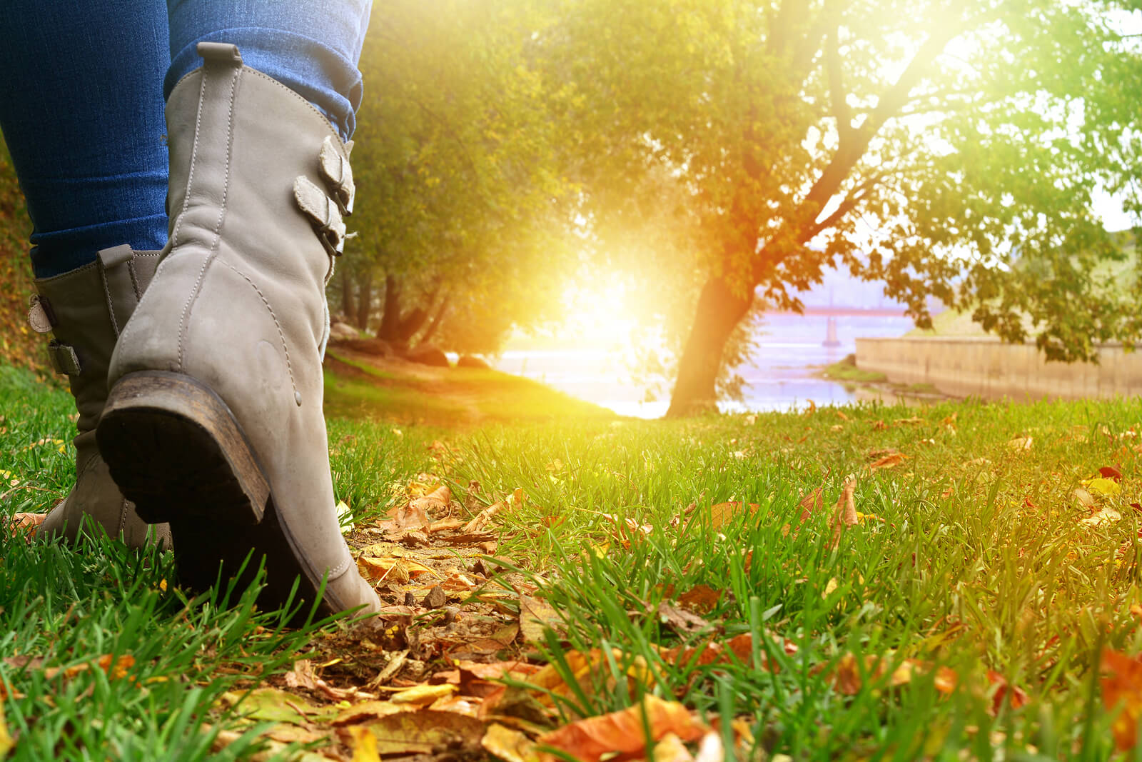 A close up of a person in boots walking along a forest trail toward a sunset. Learn how nature can offer healing via therapy in Tigard, OR. Learn more about therapy in Tigard, OR or search for therapy for anxiety Tigard, OR to receive support. 
