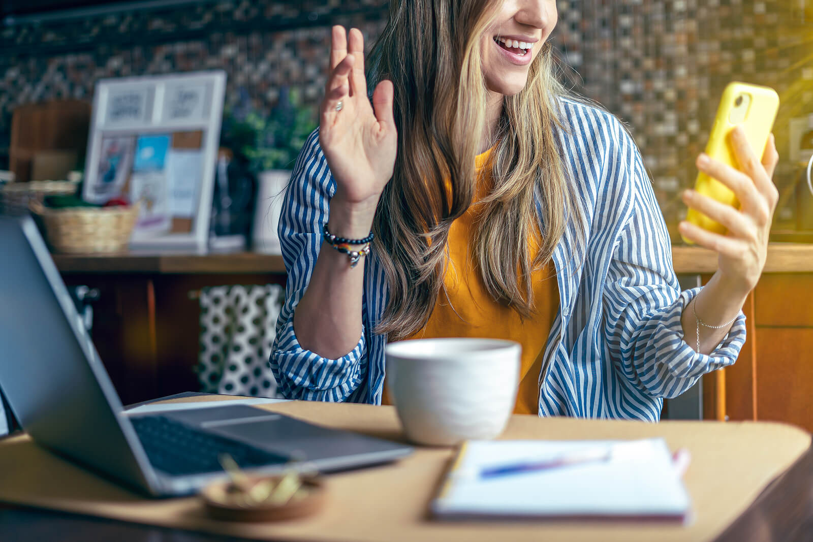 waving woman | online therapist in oregon | oregon online therapy | online therapy in oregon | 97223 | 97224 | 97281 A woman holds a phone while waving at the screen. This could symbolize the support an online therapist in Oregon can offer. Learn more about remote therapy in Tigard, OR and how a Chrsitain therapist in Tigard, OR can help today.