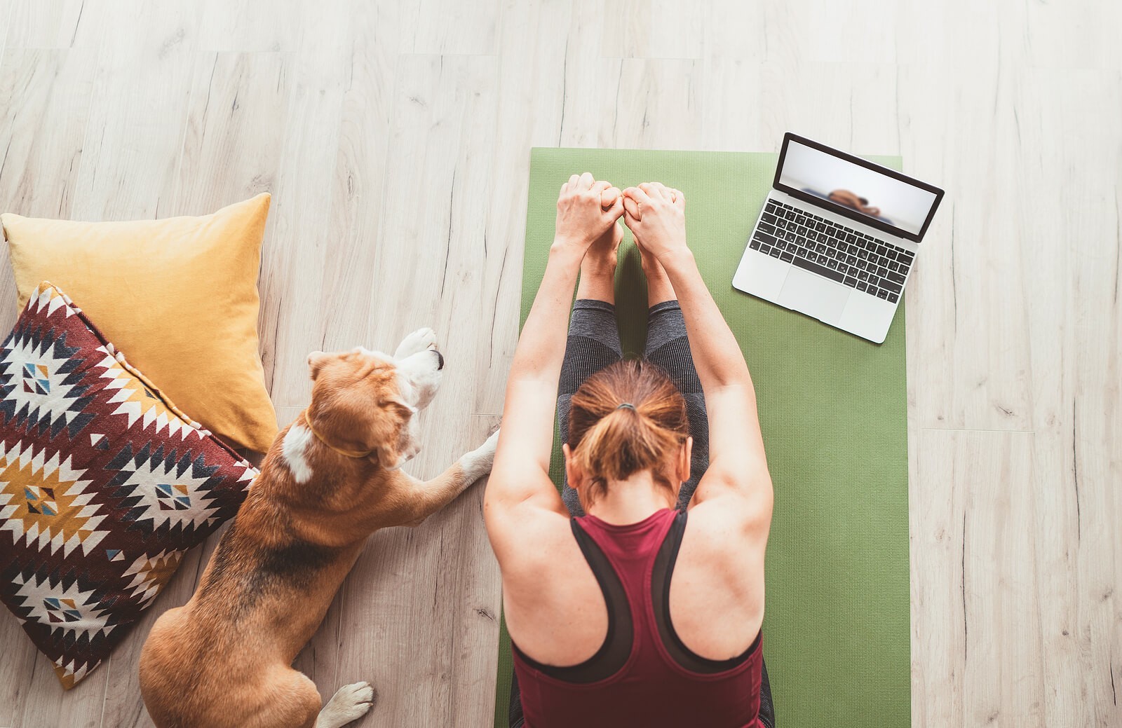 yoga with pet | anxiety therapist in tigard, or | therapy in tigard, or | anxiety treatment in tigard, or | 97223 | 97224 | 97281 A top down view of a woman sitting in a yoga pose on a mat with her pet dog and laptop nearby. The yoga video she is watching on her laptop could represent getting support with finding new anxiety management techniques. Learn how an online therapist in Oregon can offer support by searching for therapy in Tigard, OR. You can connect with an anxiety therapist in Tigard, OR today.