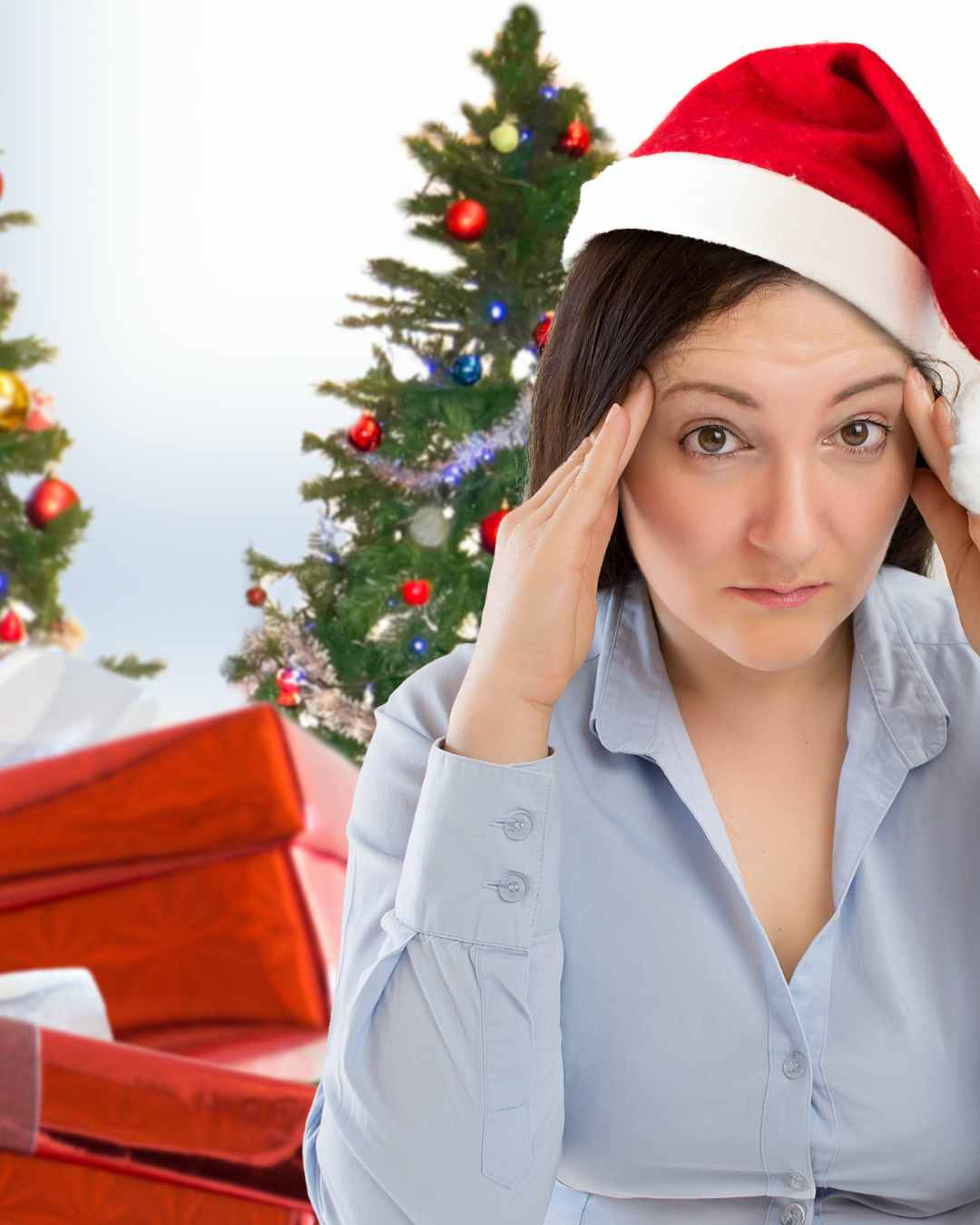 Santa Worry Stress | Online therapy in Oregon | Best therapist in Tigard, OR | Anxiety therapy in Oregon A woman wearing a Santa hat holds her head and looks stressed, with Christmas trees and wrapped presents in the background. Get support for your mental health from the best therapist in Tigard, OR and online therapist in Oregon.