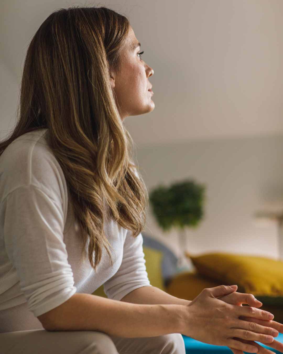 Woman sitting with hands in her lap looking upset. Is it time to go back to therapy for women in Tigard, OR? Learn more here.